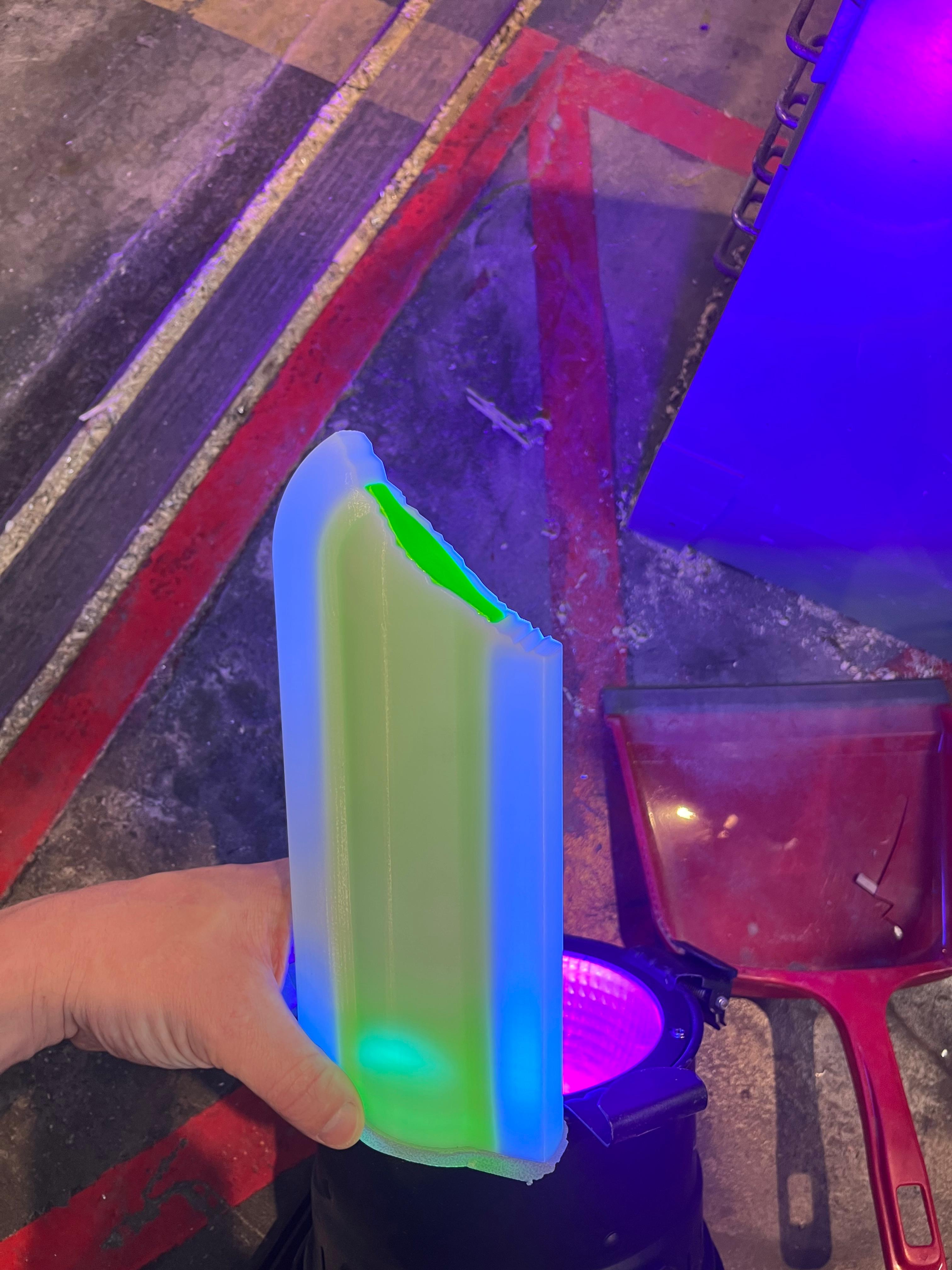 The same printed popsicle under UV light, glowing
