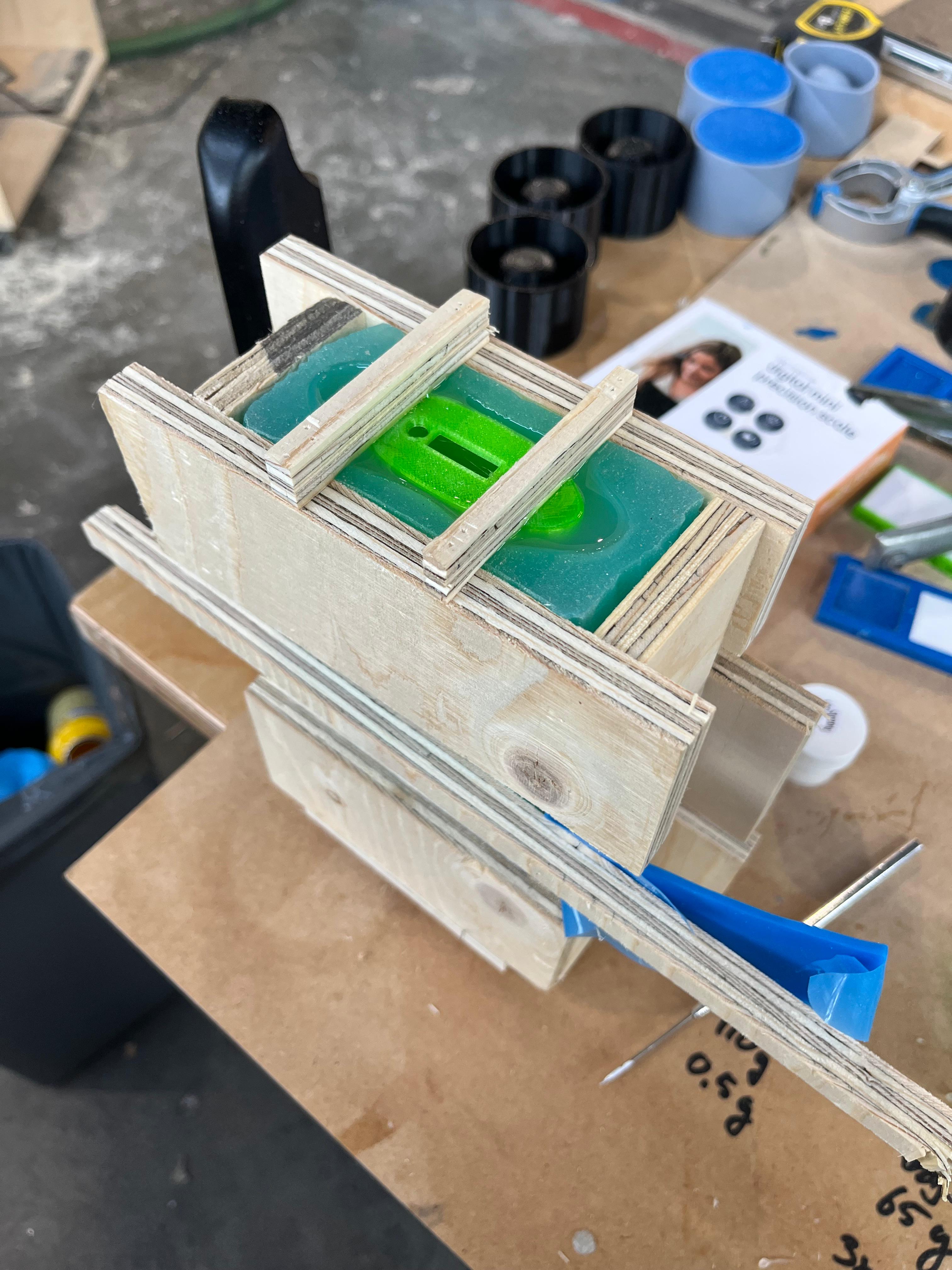 Casting jig holding printed moulds with green resin parts in them